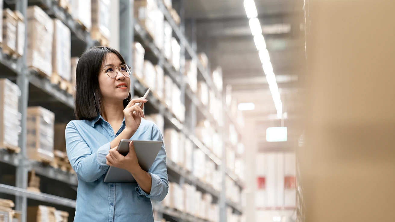 Retail Audit Companies professional inspecting warehouse inventory with a tablet